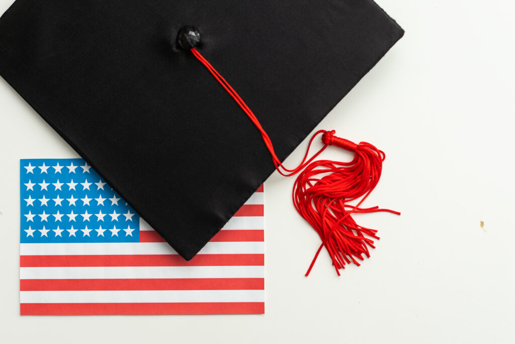 graduation hat on US flag, education concept