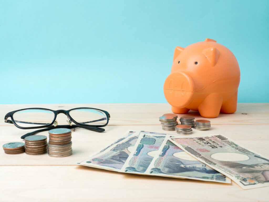 coin stack with house model, savings plans for housing blue back