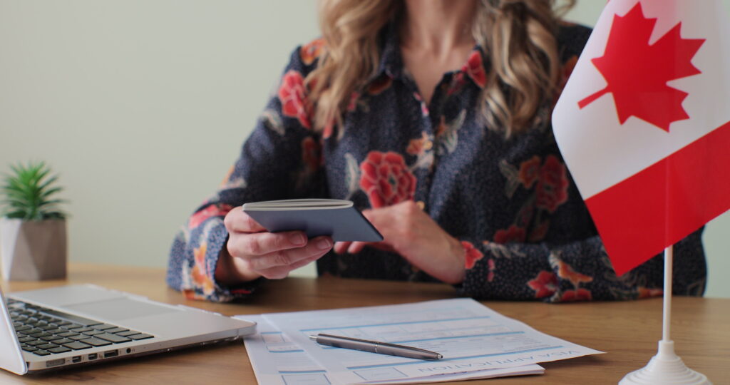 Canadian woman consular officer giving passport to male immigrant, work visa, citizenship. Visa Application online form immigration concept. Visa approval.