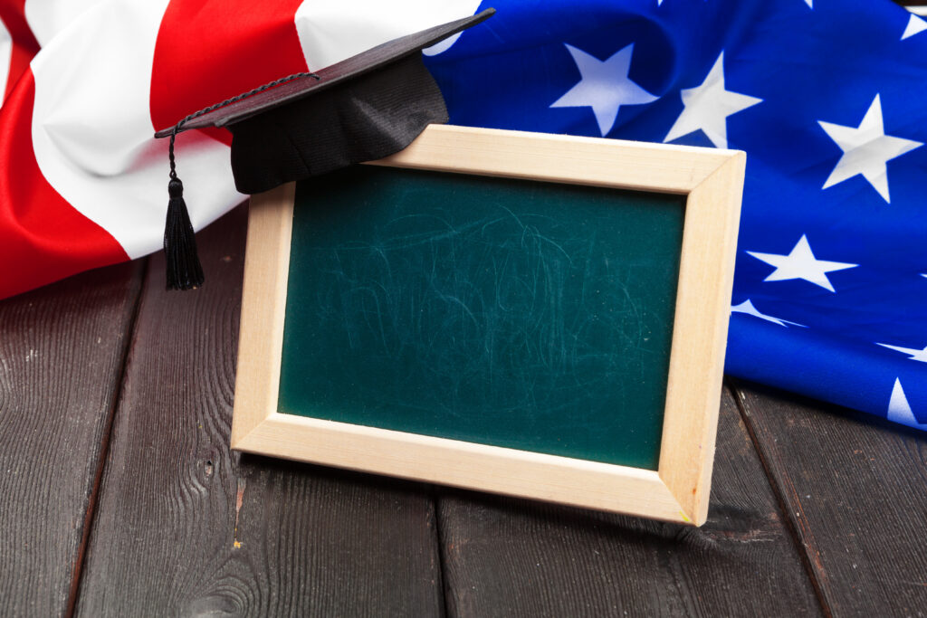 graduation hat on US flag, education concept