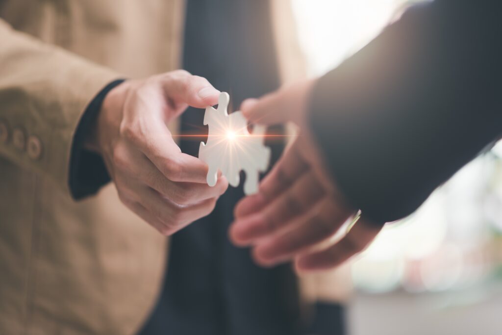 Businessman,Puzzle,Pieces,,Solution,Concept,,Teamwork,And,Brainstorm,From,A