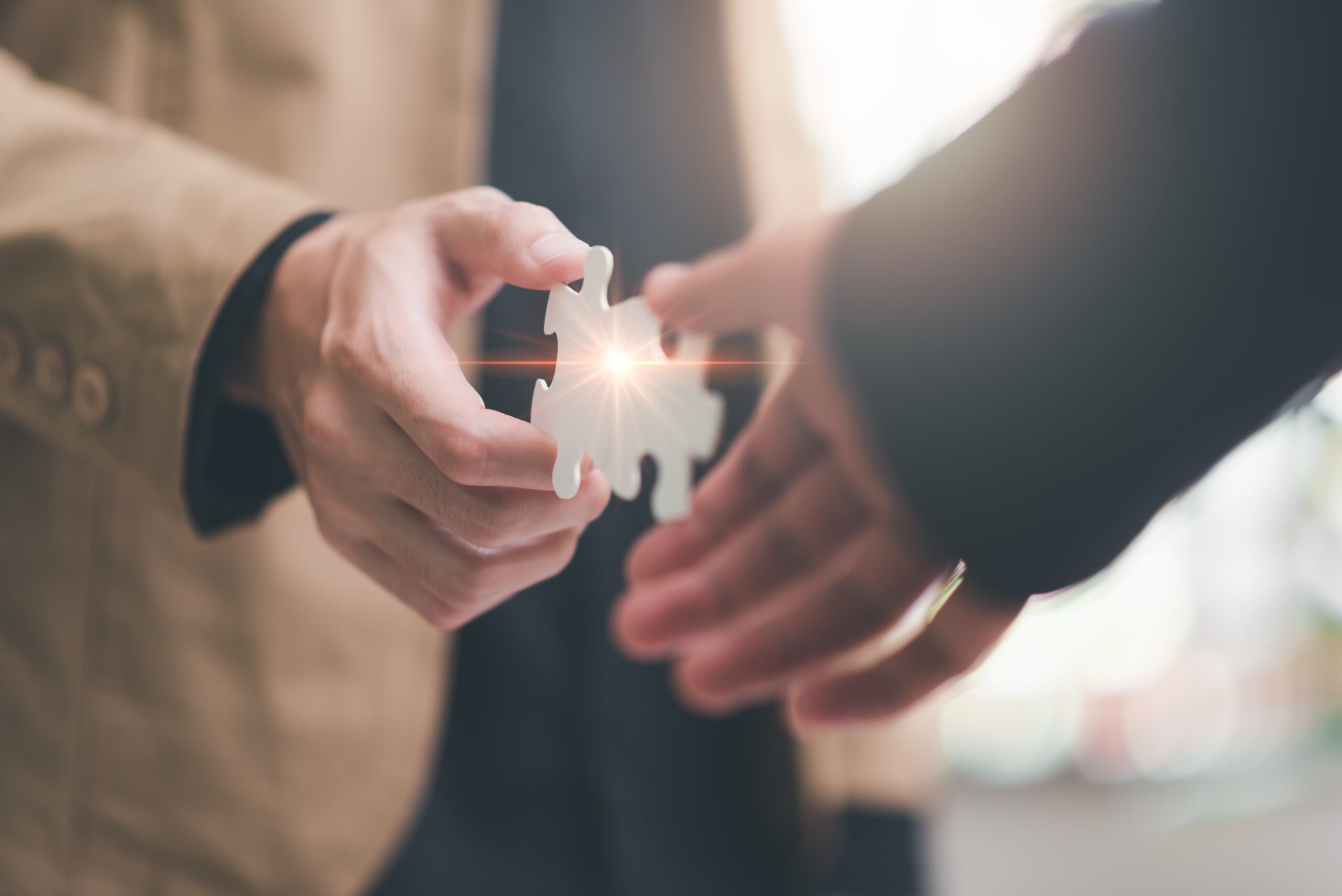 Businessman,Puzzle,Pieces,,Solution,Concept,,Teamwork,And,Brainstorm,From,A