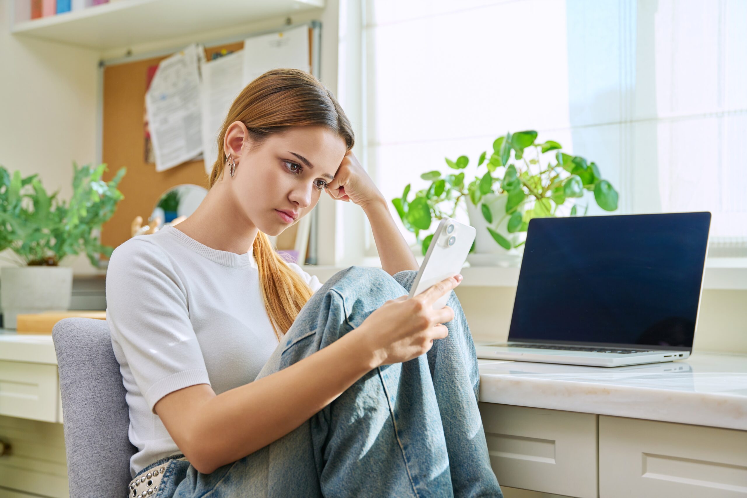 Upset,Sad,Young,Female,Sitting,At,Home,With,Smartphone