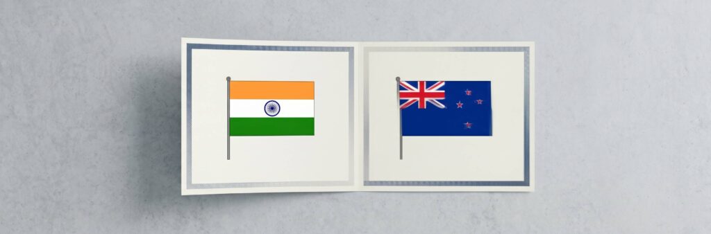 A minimal editorial cover image showing two clean, modern academic certificates placed side by side on a neutral surface, with a subtle seamless overlap or shared edge between them forming a single continuous document, soft natural lighting, neutral tones (white, light grey, soft blue), no text, no flags, no icons, very few elements, ultra-realistic photography style, strong negative space, top-down composition, symbolizing dual degrees and mutual recognition between two countries, cinematic wide. WIth flags of India and New Zealand.