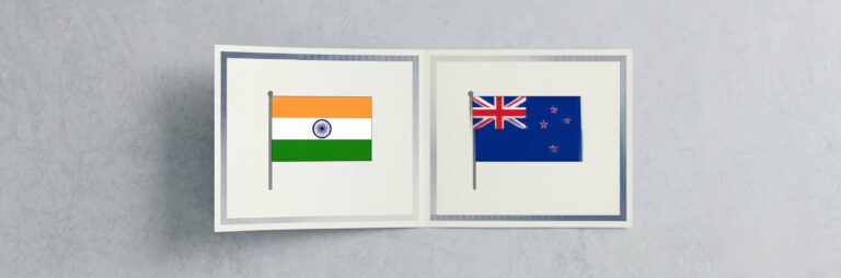 A minimal editorial cover image showing two clean, modern academic certificates placed side by side on a neutral surface, with a subtle seamless overlap or shared edge between them forming a single continuous document, soft natural lighting, neutral tones (white, light grey, soft blue), no text, no flags, no icons, very few elements, ultra-realistic photography style, strong negative space, top-down composition, symbolizing dual degrees and mutual recognition between two countries, cinematic wide. WIth flags of India and New Zealand.