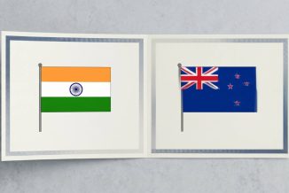 A minimal editorial cover image showing two clean, modern academic certificates placed side by side on a neutral surface, with a subtle seamless overlap or shared edge between them forming a single continuous document, soft natural lighting, neutral tones (white, light grey, soft blue), no text, no flags, no icons, very few elements, ultra-realistic photography style, strong negative space, top-down composition, symbolizing dual degrees and mutual recognition between two countries, cinematic wide. WIth flags of India and New Zealand.